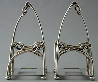 Archibald Knox. A pair of silver toast racks. 1905.